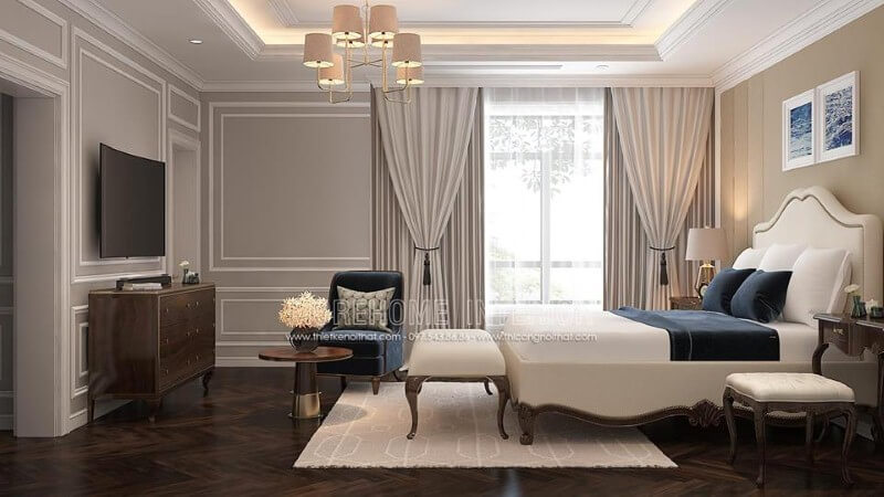 Giường bọc nệm trắng kết hợp sắc trầm từ ghế, đôn sofa, kệ tivi gỗ óc chó đã tạo nên bức tranh hài hòa, đẹp, sang trọng trong phòng ngủ master tân cổ điển.